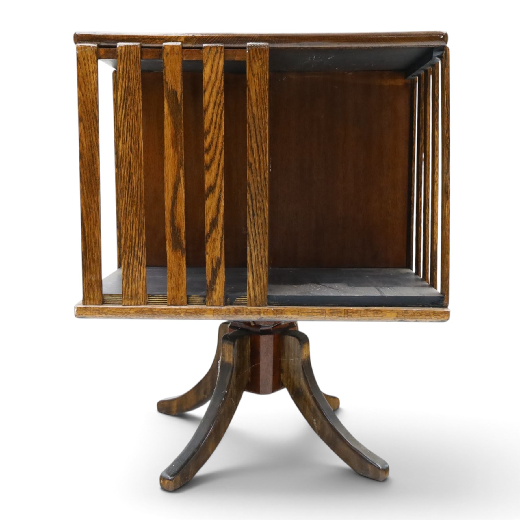 Early 20th century oak revolving bookcase, square top above four divided sections, raised on a revolving base