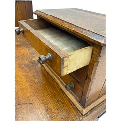 Late 19th century heavily carved oak twin pedestal desk, rectangular top with two raised trinket or correspondence structures each with three drawers, rectangular top over three frieze drawers carved with acorn and oak leaf decoration, each pedestal with three drawers with acorn husk shaped handles