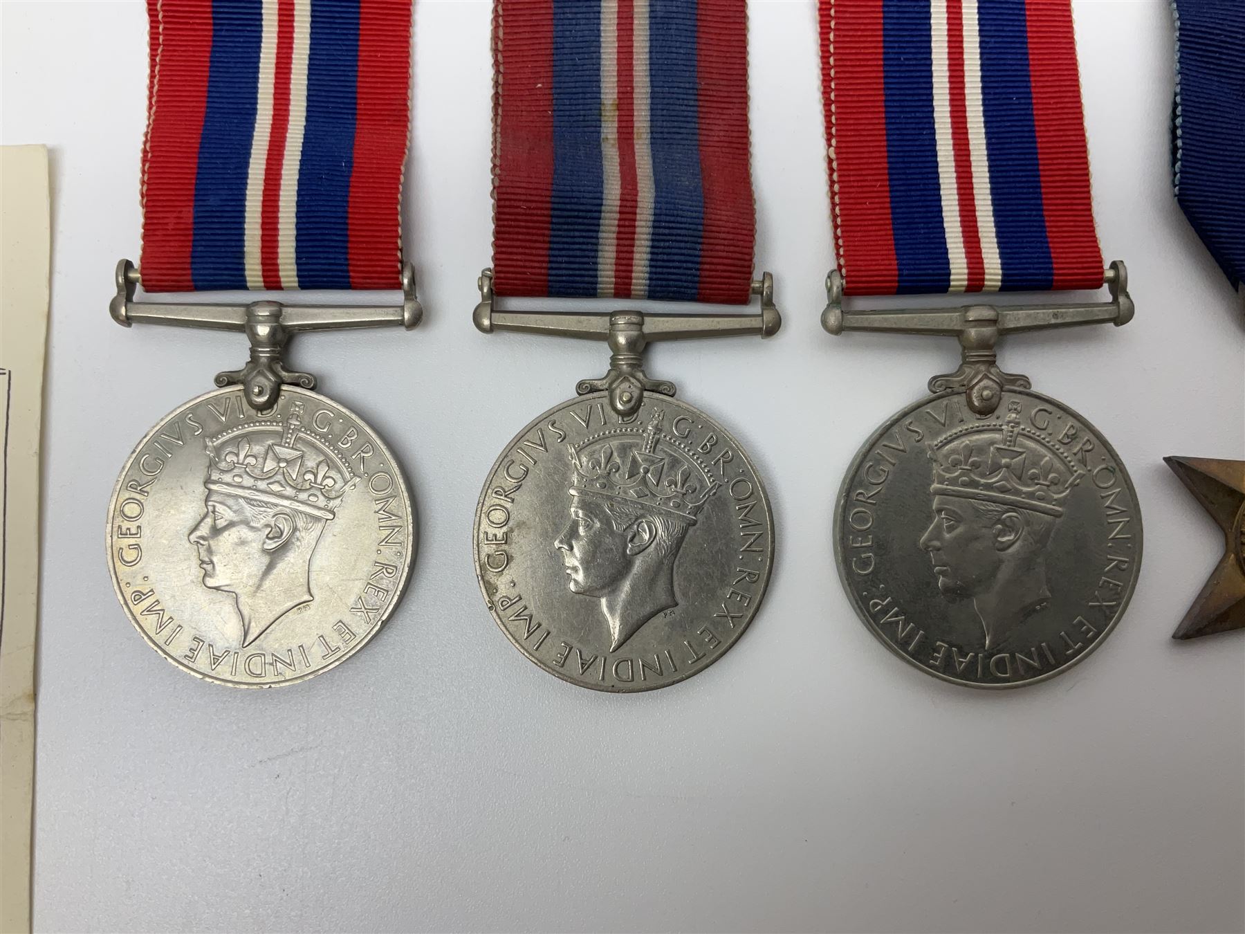 Eleven WW2 medals comprising three 1939-1945 war medals, two Defence medals, three 1939-1945 Stars, Atlantic Star, Africa Star and Italy Star; miniature QEII Naval LS & GC medal; all with ribbons; and WW2 postumous medal slip to Flight Sergeant L.N. Clark
