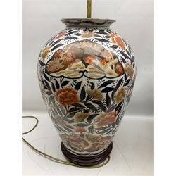 Pair of large and impressive 20th century Japanese Imari table lamps, each of ovoid form, decorated in the Imari palette with roundels containing flowering urns, and shaped panels of birds, set against a white ground decorated with blossoming peonies, lamp base (not including fixtures) H56.5cm overall including shade H89cm