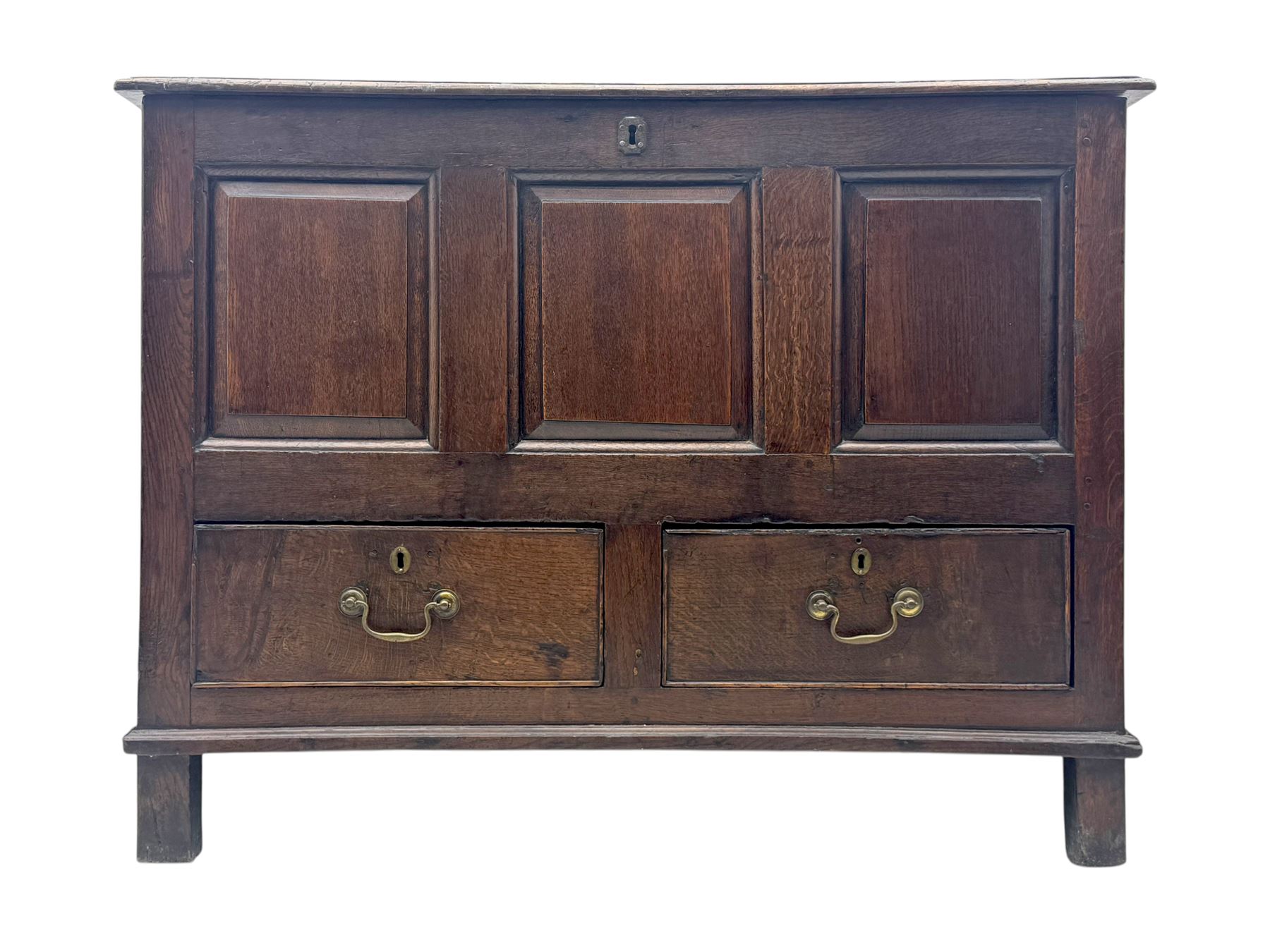 Early 18th century oak mule chest, hinged rectangular top above three recessed panels and two drawers, each fitted with brass drop handles, open interior fitted with candle box compartment, raised on square supports
