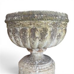20th century good quality weathered cast stone pedestal urn of ecclesiastical design, circular lobed bowl with rope twist and lattice border, raised on squat base with fluted column  and acanthus decorated base