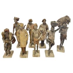 Eight 19th Century Indian clay dolls, possibly Krishnanagar, each figure with painted details, wearing cloth garments, standing on rectangular bases, some with paper label to the base, H28cm
