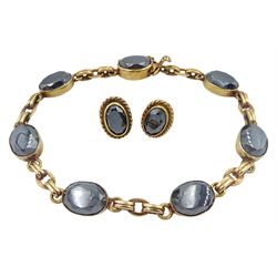 Gold oval haematite bracelet and a pair of gold matching stud earrings, both hallmarked 9ct