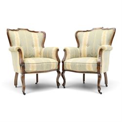 Edwardian mahogany three-piece salon suite, comprising settee and two armchairs, shaped frames with upholstered backs, scrolled arm supports and serpentine seat rails, upholstered in striped floral damask fabric, on cabriole supports with castors (Armchairs: H 96cm, W 70cm, D 68cm)