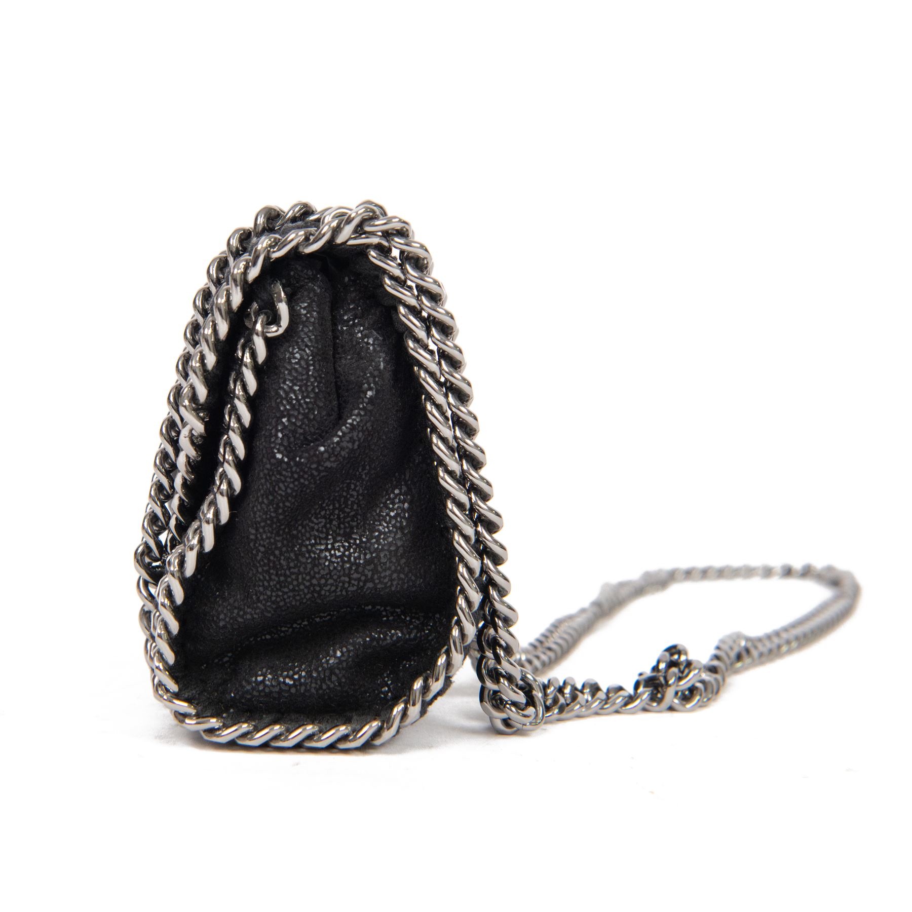 Stella McCartney Falabella black shaggy deer cross-body bag, the compact foldover design with signature silver-tone curb chain trim and chain strap, logo disc charm and pink logo lining, stamped Stella McCartney Made in Italy, with dust bag