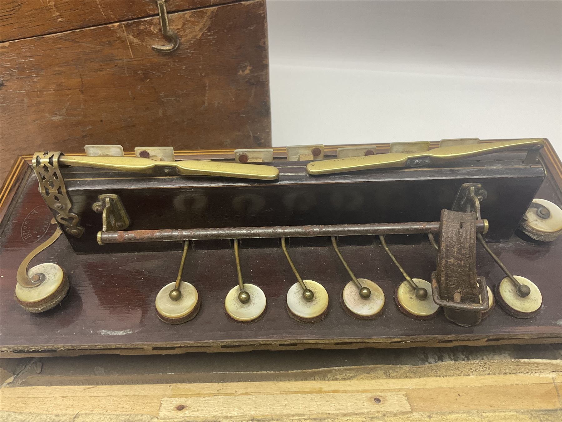 19th Century inlaid rosewood Flutina accordion, stamped Busson of Paris, having sixteen mother of pearl keys and six fold floral decorated bellows L30cm; in baize lined mahogany box