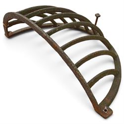 Victorian wrought iron wall-mounted stable hay rack of bowed cage form, with curved bars and fixing lugs