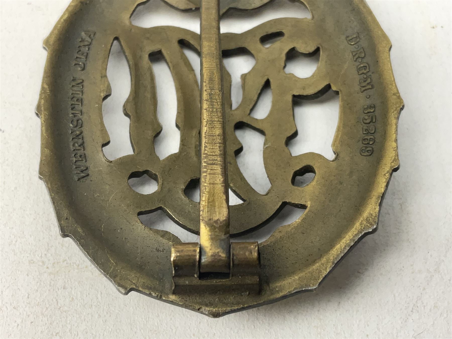 Two WW2 German Sports badges - SA sports badge marked verso 'W.Redo Eigentum D. Obersten SA. Fuhrung Saar Lautern'; and DRL sports badge marked verso 'Wernstein Jena D.R.G.M. 35269' (2)