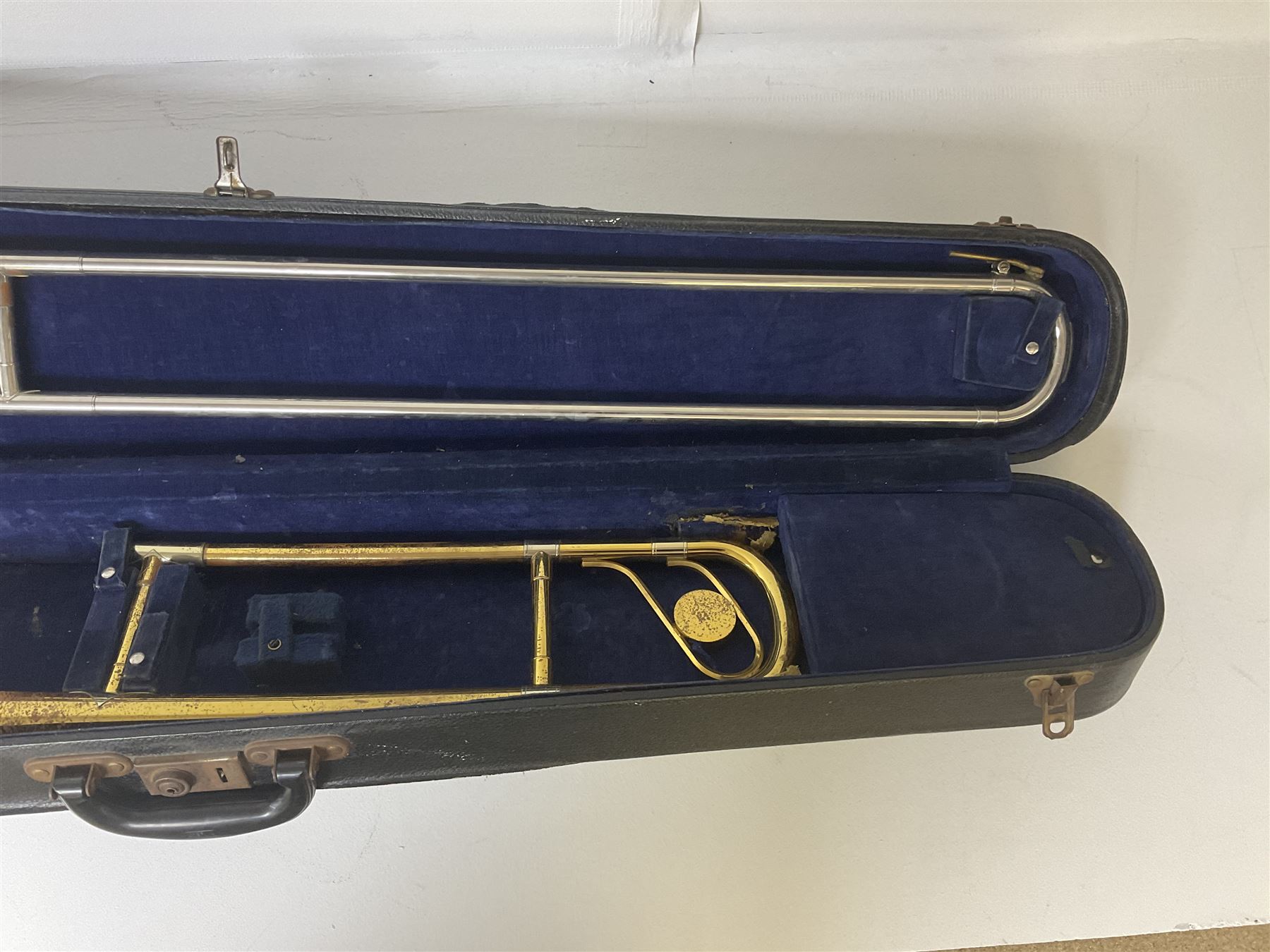 Three brass trombones comprising Elkhart Ind. USA 'CONN' model no.72H; Besson 'Concord'; and Selmer Distributed 'Lincoln'; two in carrying cases; and German B & M 'Champion' brass trumpet (4)