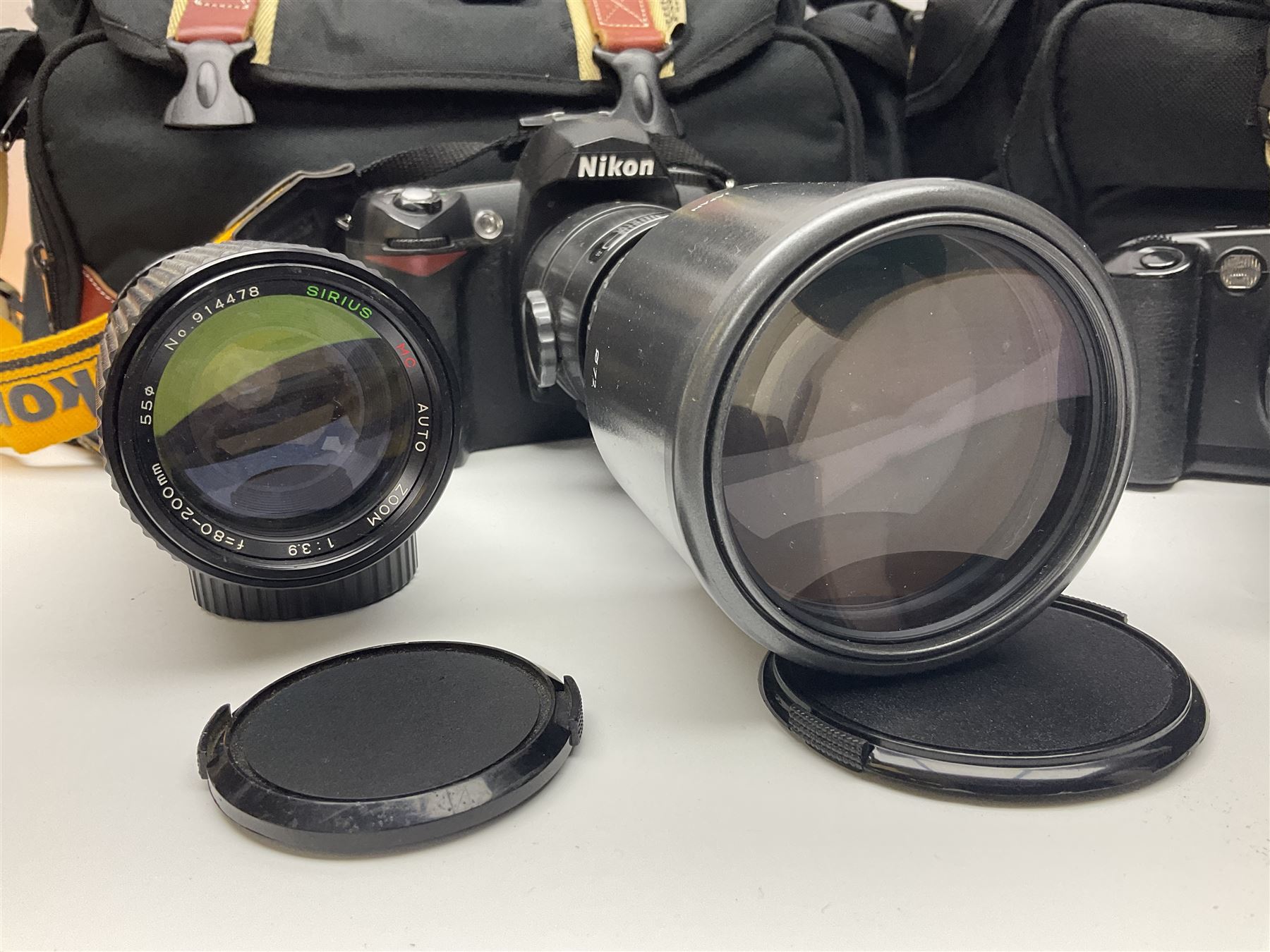 Four camera bodies, to include, Ricoh KR-10 serial no. 38826, Pentax MZ-M serial no. 4185969 with 'SMC Pentax- M 1:3.5 28mm' lens, Canon EOS500 serial no. 080927, with 'Sigma Zoom 100-300mm 1:4.5-6.7 DL'  lens etc, with other camera lenses and equipment 