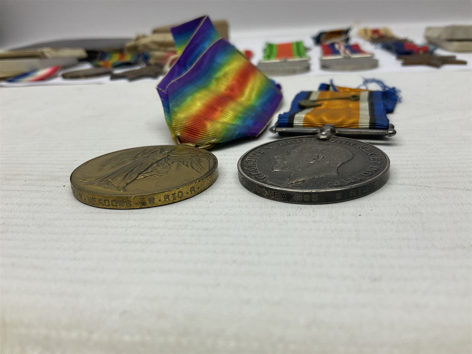 WWI pair of medals comprising British War Medal and Victory Medal awarded to 32682 Pte. W. Meadows W. Rid. R. in issue box; WWI pair of medals comprising 1914-15 Star and Victory Medal awarded to 3720 Pte. (later Cpl.) E. Petty W. York. R. with issue letter from Tank Corps; WWII group of five medals comprising 1939-45 War Medal, Defence Medal and 1939-45, Italy and Africa Stars; all with ribbons; and book of nineteen seaman's Certificates of Discharge to cook Charles Filburn 1893 - 1901 from various British ports