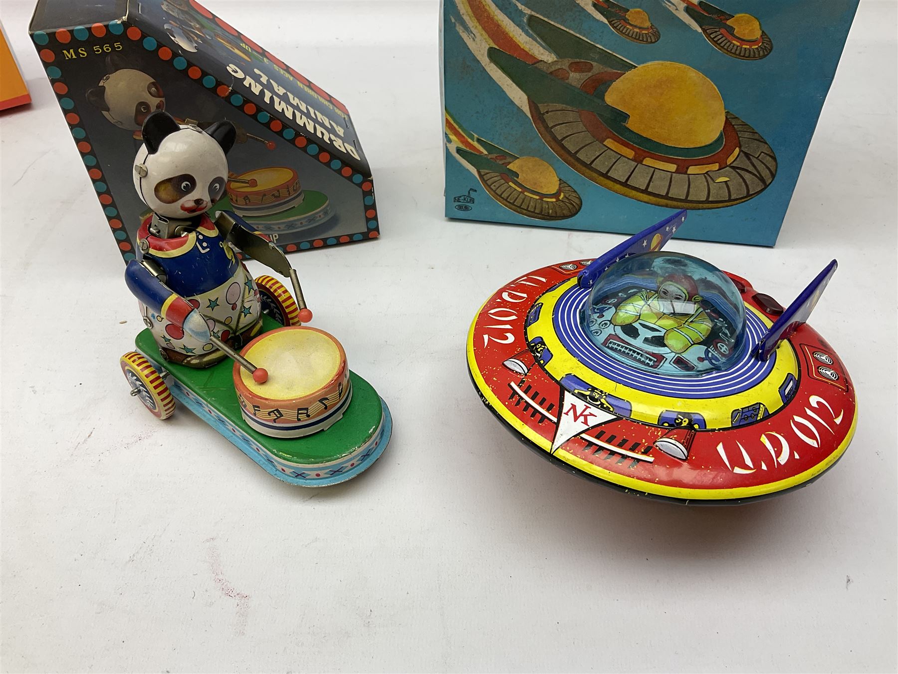 Seven modern Chinese, Japanese and Continental boxed tin-plate toys including Ucan Daire Flying Saucer, Drumming Animal, Circus Clown, Puzzle Cat, Bird with Jumping Action etc; and a quantity of clockwork toy keys (7)