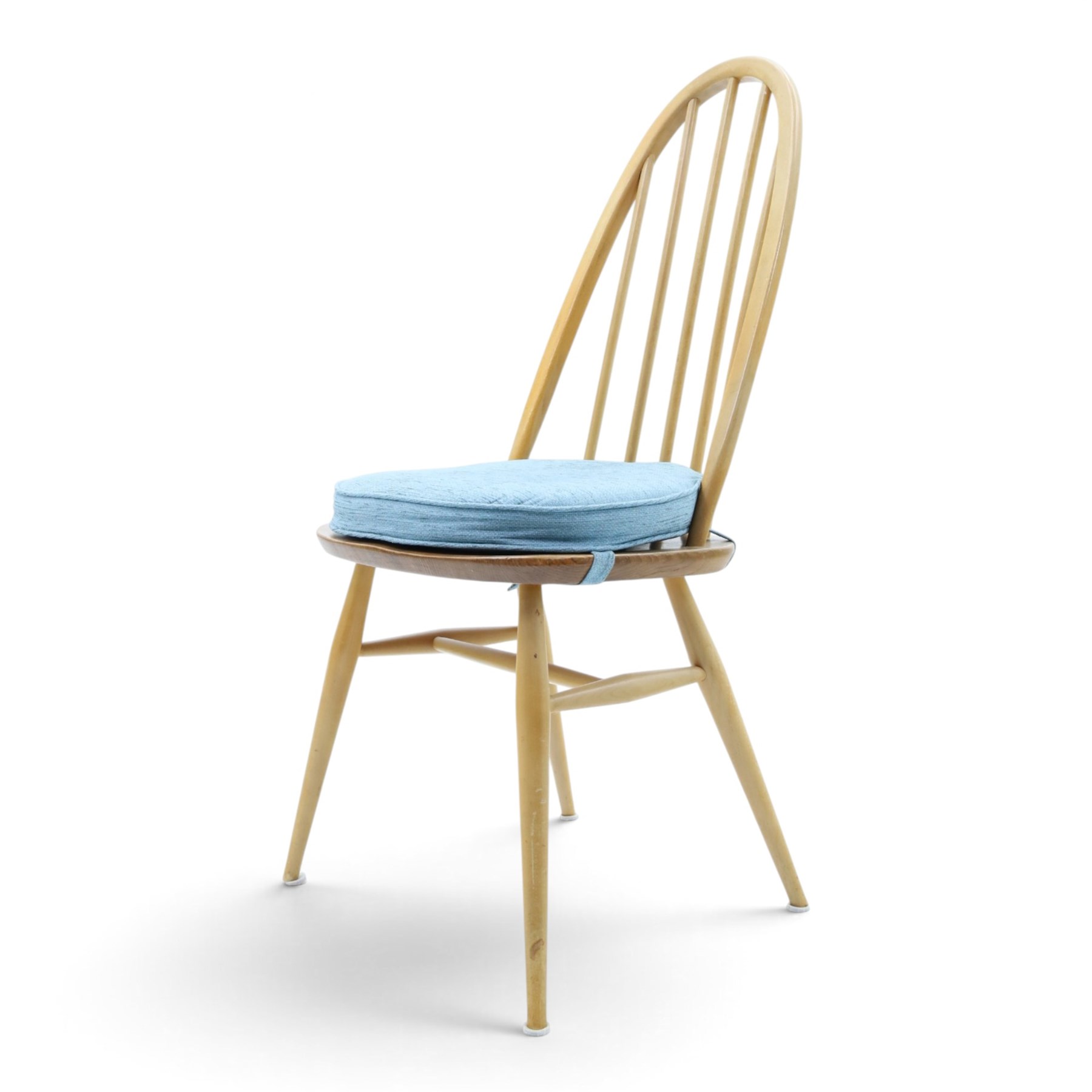 Ercol - set of four 'Quaker' dining chairs, with high hooped back, blue seat cushions with studded, tapered supports  