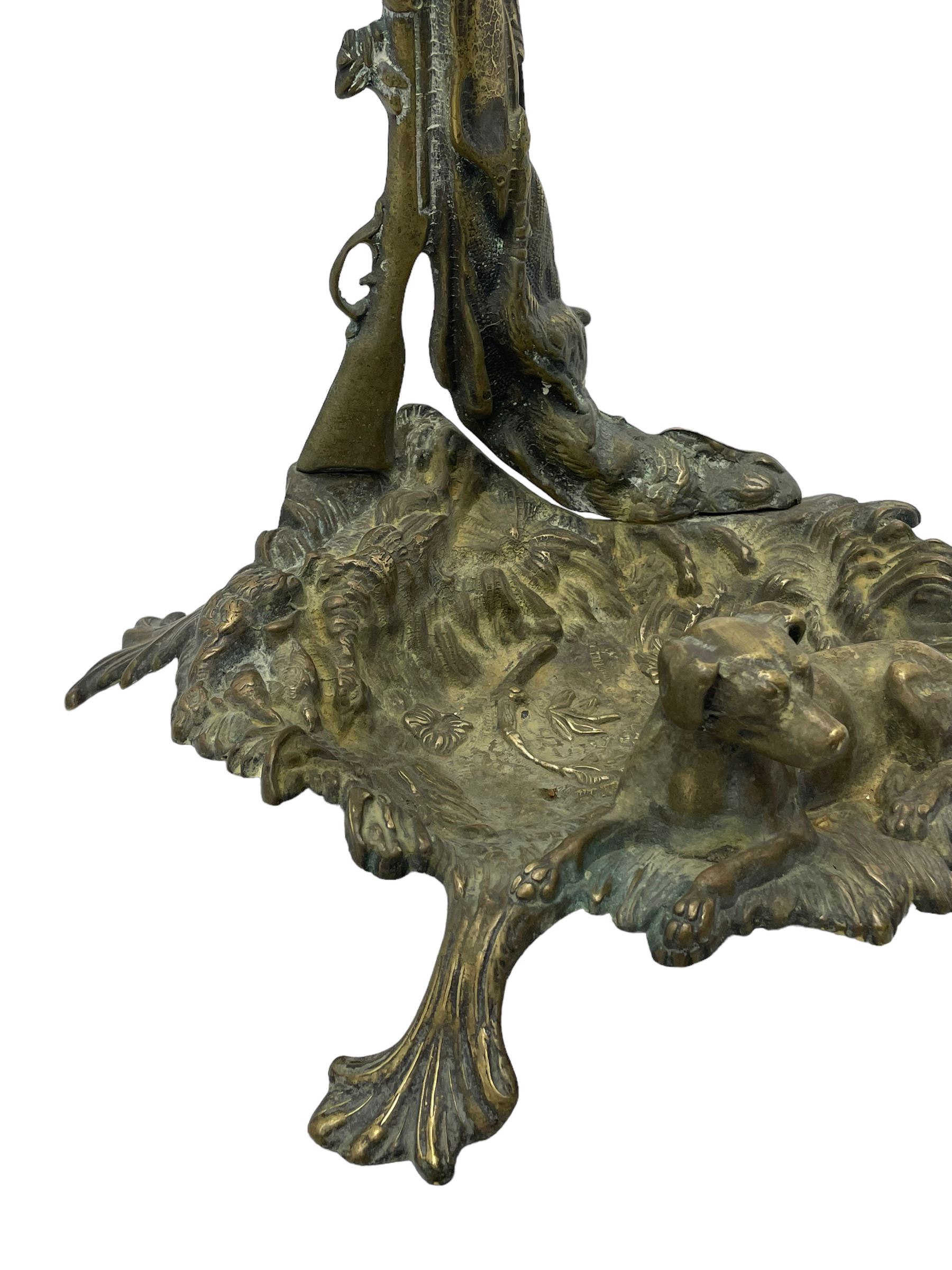 Pair of cast brass hallway umbrella or stick stands, in the form of a tree decorated with trailing flowering foliage branches, the stem with hunting horn over leaning shotgun, shaped naturalist tray base with hunting hound and out splayed foliate cast feet 
