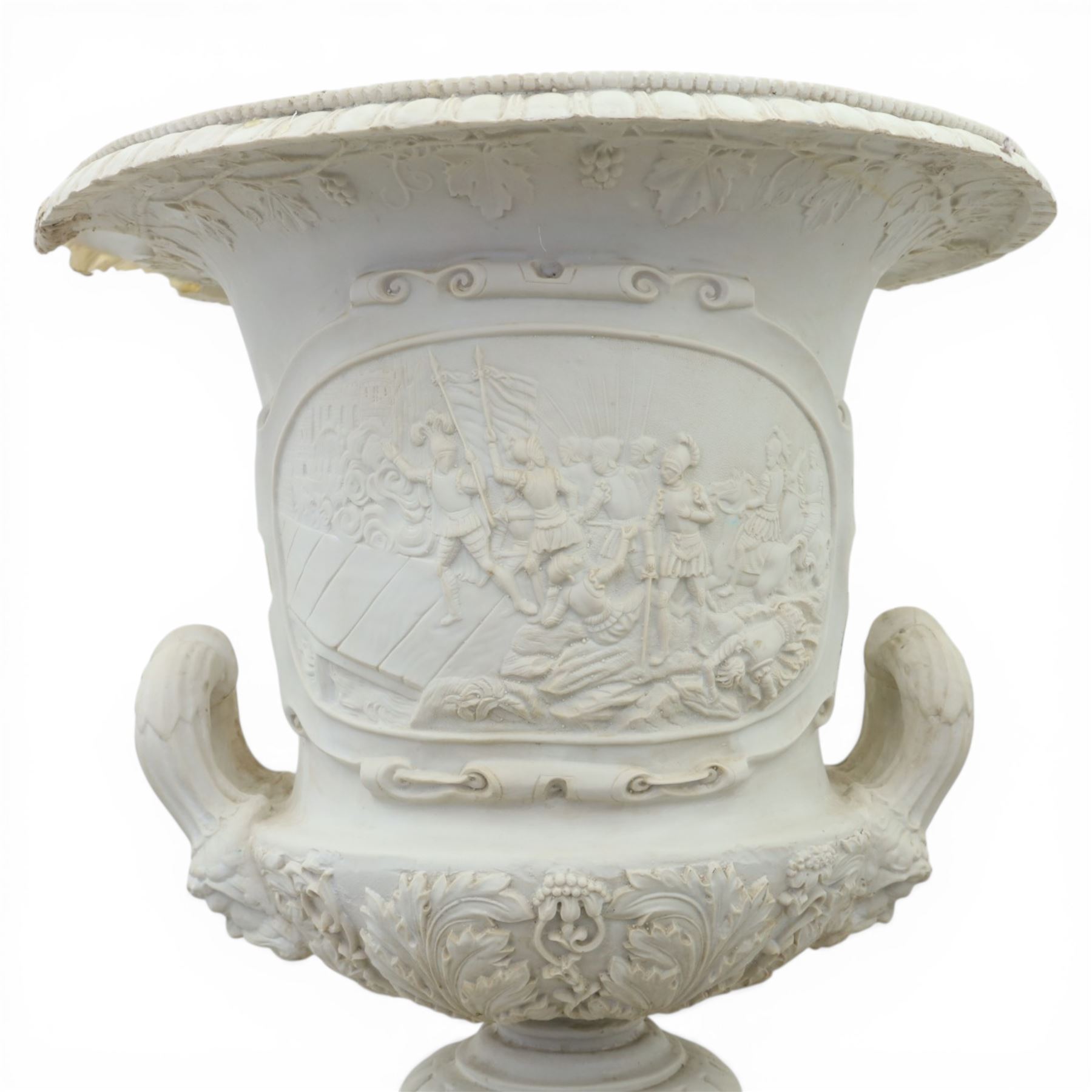 Pair of composite campana urns on stands, the urns decorated with relief figural panels and foliate bands with scrolling handles, on circular socles, the pedestals of square tapering form with moulded edges and applied classical motifs