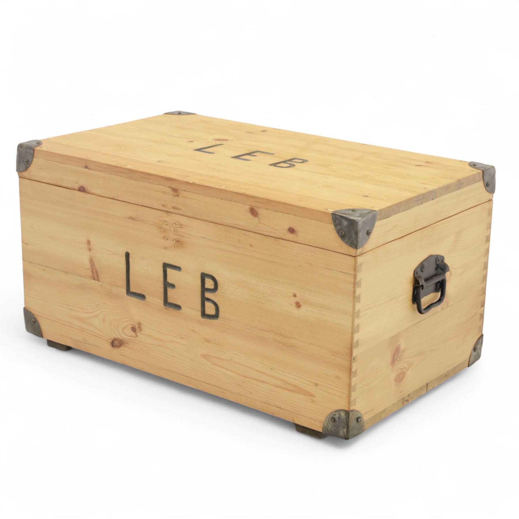 Pine storage trunk, of rectangular plank construction with metal corner protectors and stencilled lettering ‘LEB’ to front and lid