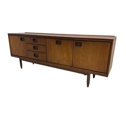 William Lawrence of Nottingham - mid-20th century teak sideboard, with low gallery back over three short drawers and a fall front, flanked by two cupboard doors, enclosing shelves, raised on tapering cylindrical supports, makers mark stamped inside drawer
