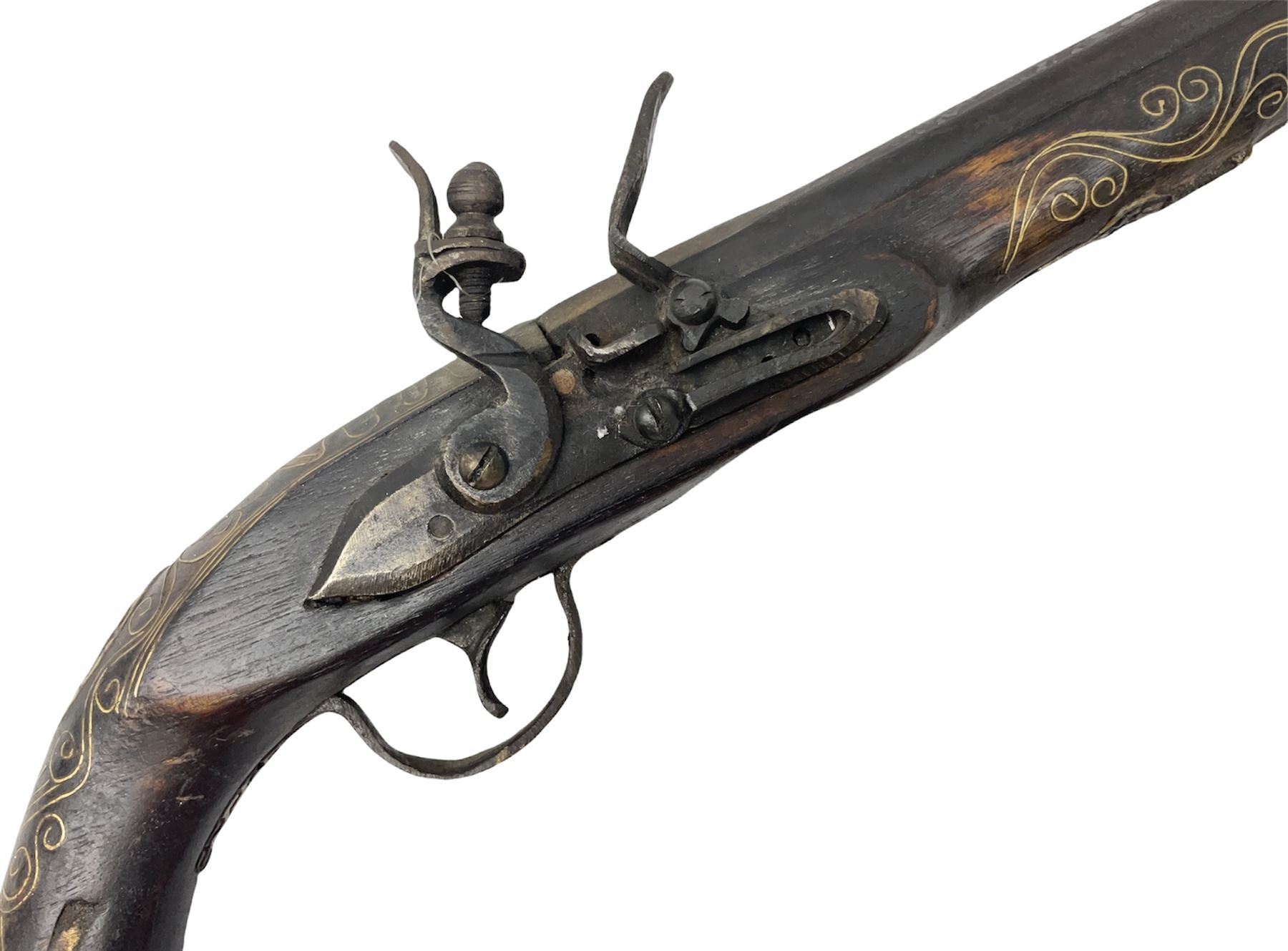 Reproduction flintlock pistol, the full walnut stock with brass filigree inlay and mounts and skull crusher butt L46cm; no visible proof marks FIREARMS CERTIFICATE REQUIRED OR RFD