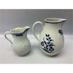 Four 18th century Worcester porcelain jugs, comprising three sparrow beak examples, the first example decorated in the Bat or Vase pattern, circa 1780, with underglaze blue disguised numeral mark beneath, the second in the Three Flowers and Butterfly pattern, the third decorated with floral and fruit spray and sprigs, and a floral moulded example decorated in the Chrysanthemum pattern, circa 1765, together with a Caughley example decorated in the Fisherman or Pleasure Boat pattern, circa 1760, with underglaze blue crescent mark beneath, and a late 18th century blue and white cabbage moulded jug, decorated in the Lady with parasol pattern, H14.5cm, (6)




