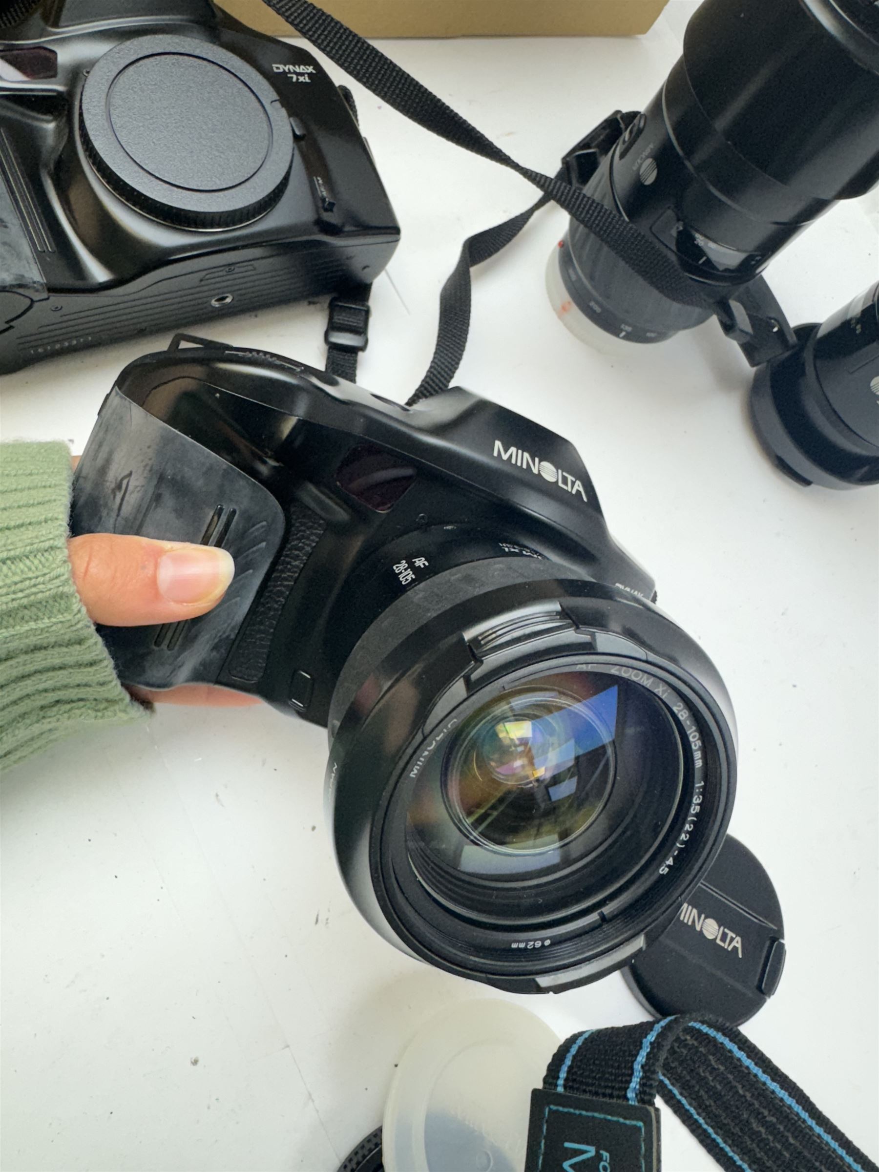 Six Minolta Dynax SLR camera bodies, comprising 800si serial no. 62703606, three 7xi examples, including one boxed example, serial nos. 20106944, 16123311 & 22107553, and two 9xi examples, serial no. 18209901 & 18202113, with three Minolta lenses, including Zoom xi 28-105mm 1:3.5(22)-4.5 lens, AF Zoom 28-85mm 1:3.5 (22)-4.5 lens and an AF Zoom 75-300mm 1:4.5(32)-5.6 lens, Hama carry case and other accessories