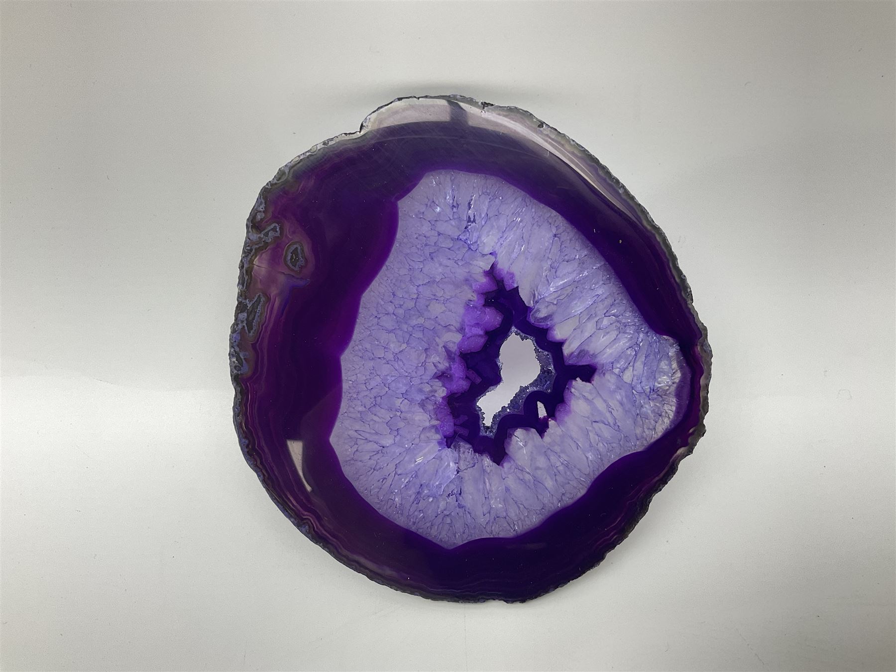Pair of purple agate slices, polished with rough edges, raised upon gilt metal stands