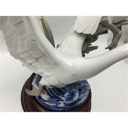 Large Lladro figure group, Swans Take Flight, modelled as two swans upon raised on circular wooden plinth, sculpted by Salvador Debon, H68cm