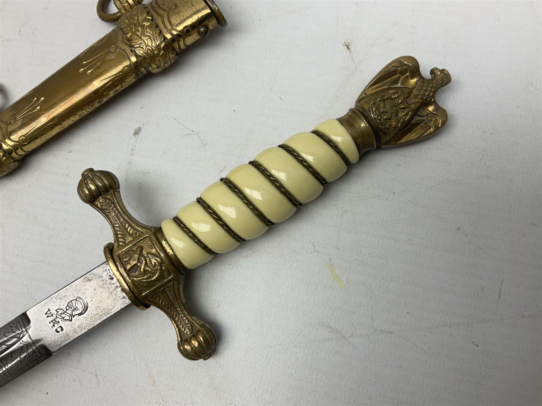 WW2 German kreigsmarine style dagger composed from various age parts, the post-war 25cm double fullered blade  with etched decoration and inscribed WKC with knight's head; in gilt brass scabbard with two rings L42cm overall