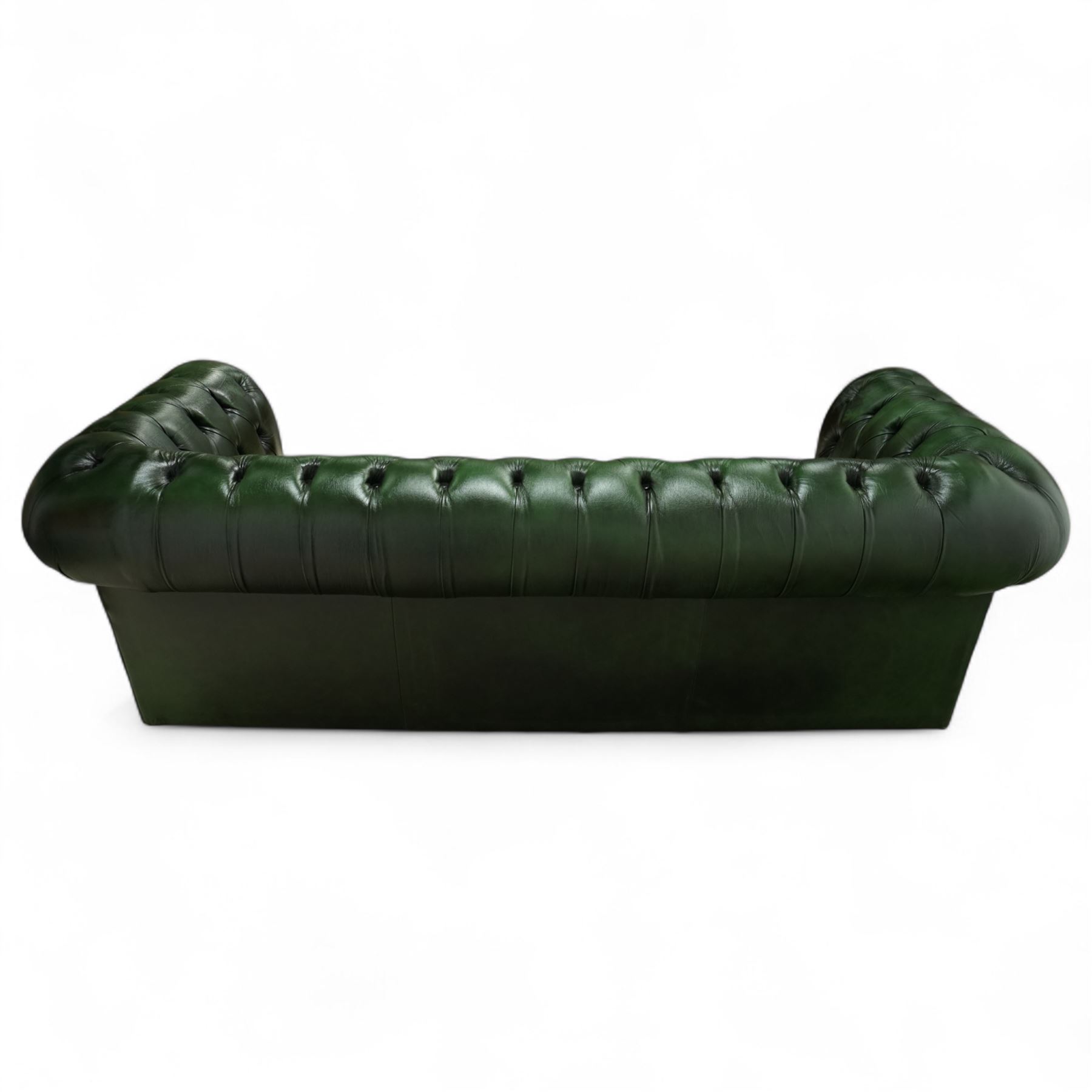 Late 20th century chesterfield style sofa upholstered in green leather, with deep buttoned back and arms above three loose cushions, continuous scroll arms and front, on concealed block feet