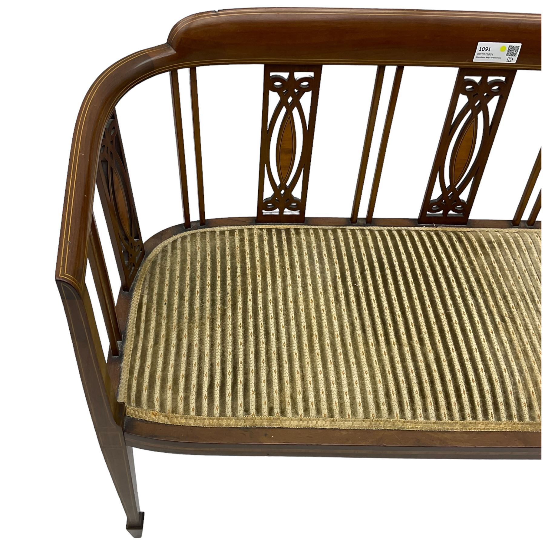 Edwardian inlaid mahogany two-seat salon sofa, curved back and arms inlaid with boxwood stringing, vertical slat back with pierced splats inlaid with satinwood, upholstered seat, on square tapering front supports with spade feet 