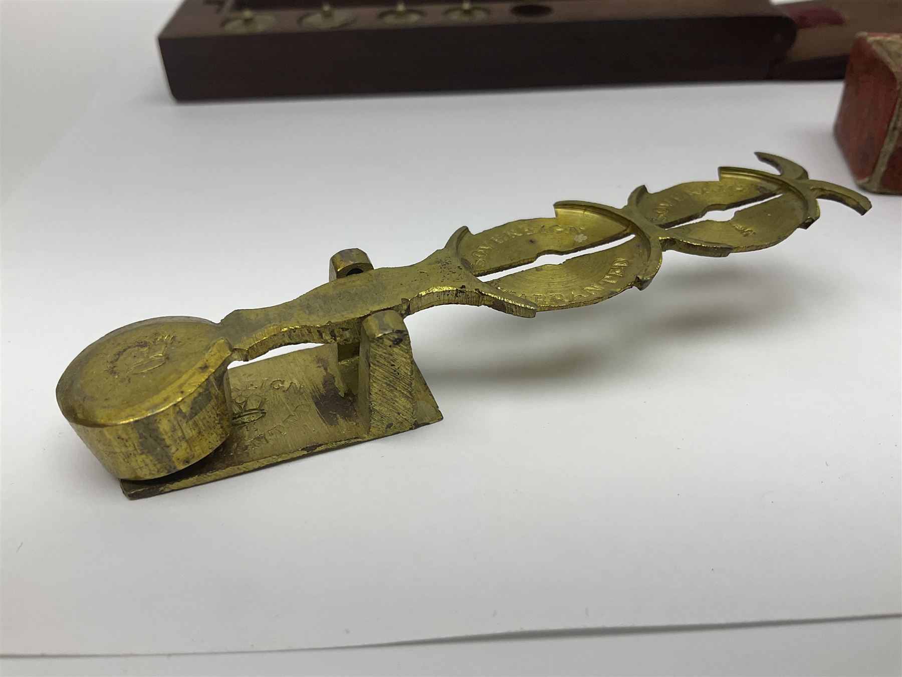Brass sovereign scales and a part set of Georgian folding sovereign scales (one weight missing)