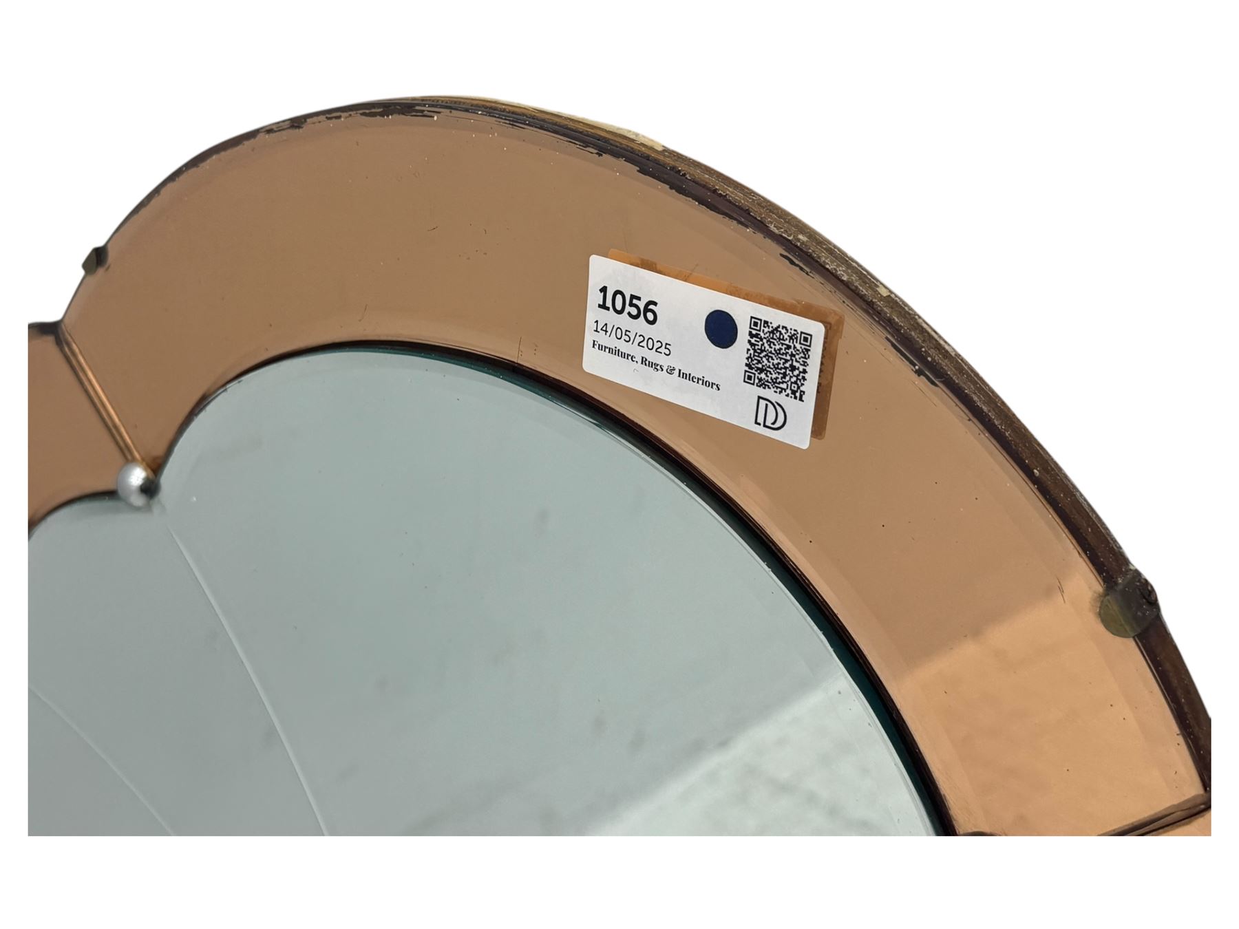 Frameless art deco mirror, scalloped copper tinted border central fan motif, bevelled edges with decorative screw caps