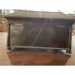 Early 19th century rosewood and brass inlaid tea caddy, of sarcophagus form, the front and hinged opening cover inlaid with brass scrolling panels, opening to reveal a compartmented interior with twin removable boxes with conforming inlaid brass detail to the hinged covers and zinc lining to the interiors, flanking a later glass mixing bowl, the whole upon four turned cylindrical feet, H21cm W36cm D20cm