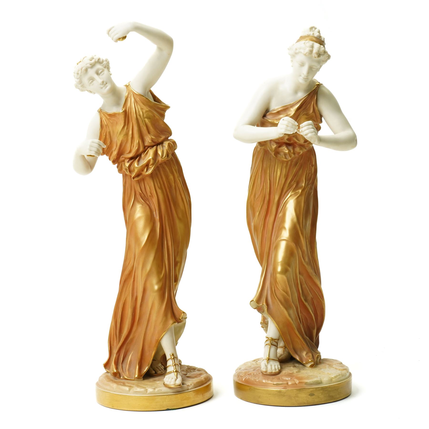 Pair of Royal Worcester figures of female musicians modelled by James Hadley, one with cymbals, decorated in gilt and on circular bases H33cm  