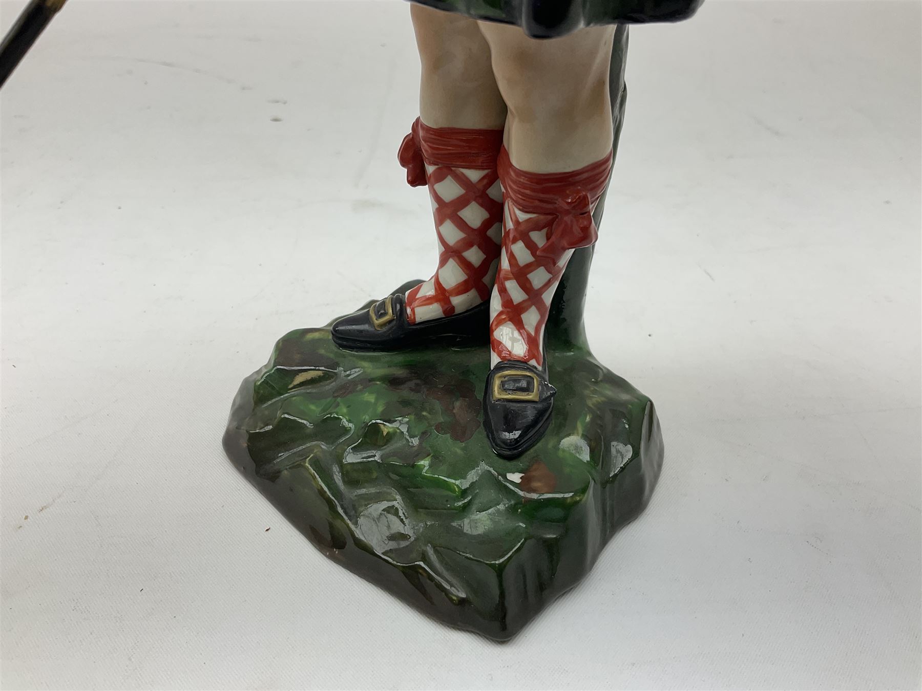 Sitzendorf figure, The Black Watch officer, c1815 standing to attention in full dress with sword, blue factory marks beneath, H28cm