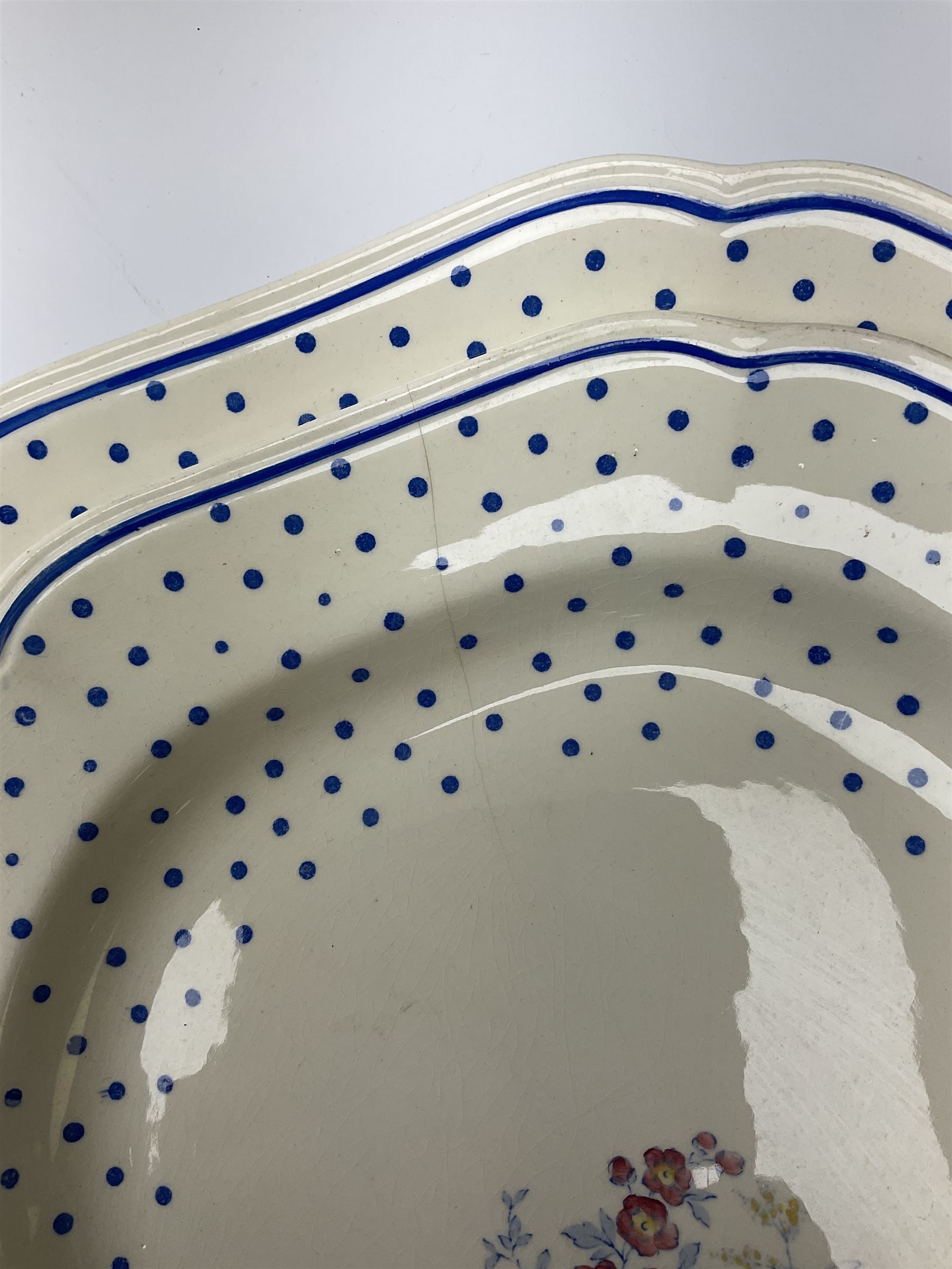 Copeland Spode Polka Dot pattern dinner and tea wares, comprising four dinner plates, seven salad plates, four dessert plates, six twin handled soup bowls and two saucers, six chocolate cups with covers and six saucers, two sauce boats, two tureens and covers, and four graduated serving platters. 