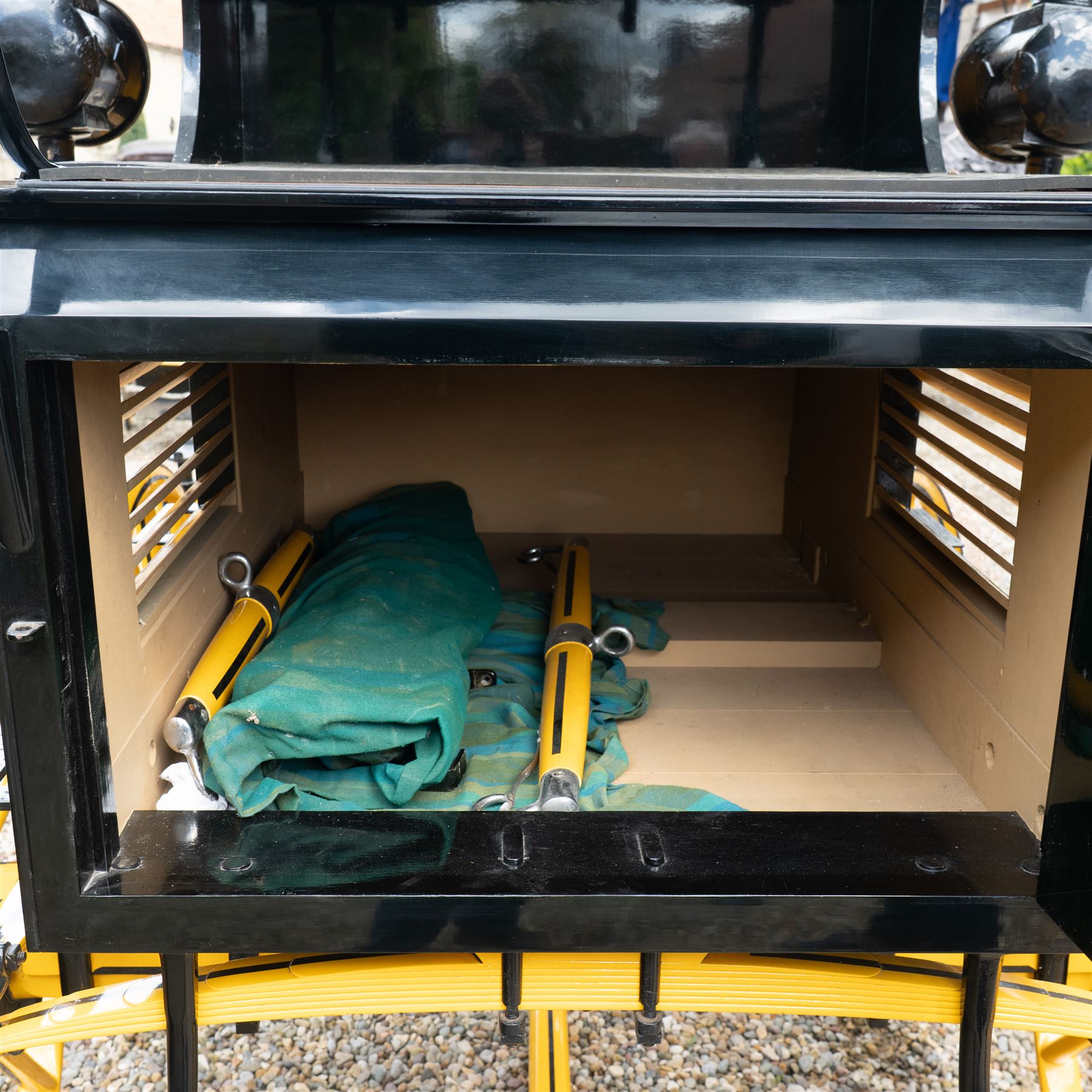 Roof Seat Break by Shanks of London

A roof seat break by Shanks of London built on a perch in black and yellow livery, the body fitted with an elevated driver's box seat, elevated rear groom's seat and central passenger compartment. The carriage is mounted on wooden spoked wheels with leaf spring suspension and is equipped with louvred underbody storage compartments, carriage lamp brackets (lamps next lot), folding access steps and a pole for driving with a pair or team of horses. The wheel hubs are stamped 