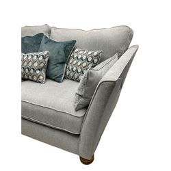 Oak Furnitureland - 'Gainsborough' lounge suite - three seat sofa, out-swept arms with loose cushions on turned oak feet, upholstered in 'Minerva Silver' fabric (W209cm D102cm H80cm); matching armchair or snuggler settee (W125cm); and rectangular ottoman footstool