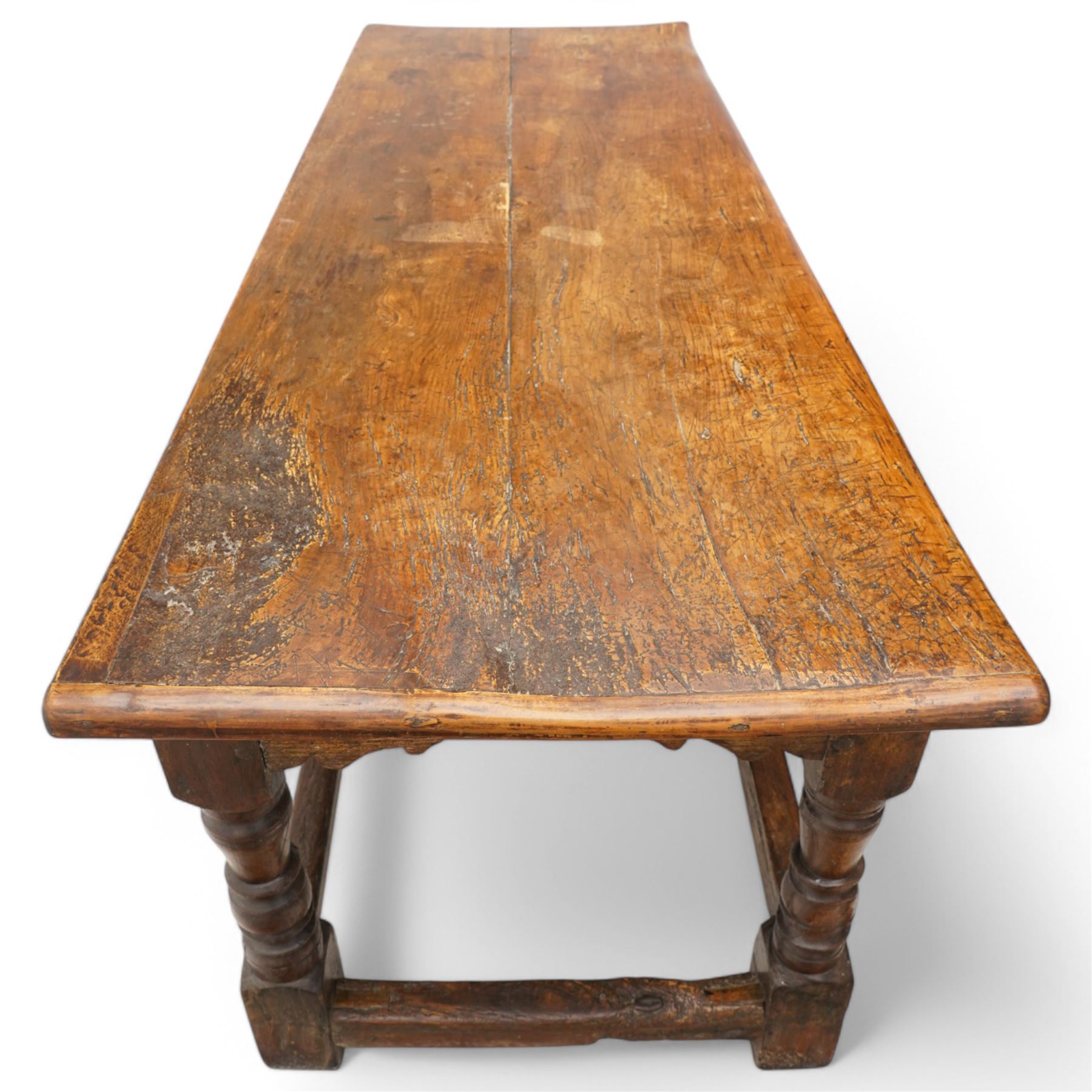 Charles I rectangular joined oak and elm refectory table, the frieze carved with repeated arch motifs, pearwood top above four turned supports united by horizontal stretcher, first half 17th century
Provenance: Purchased from Thorpe & Foster of Dorking in 1971
