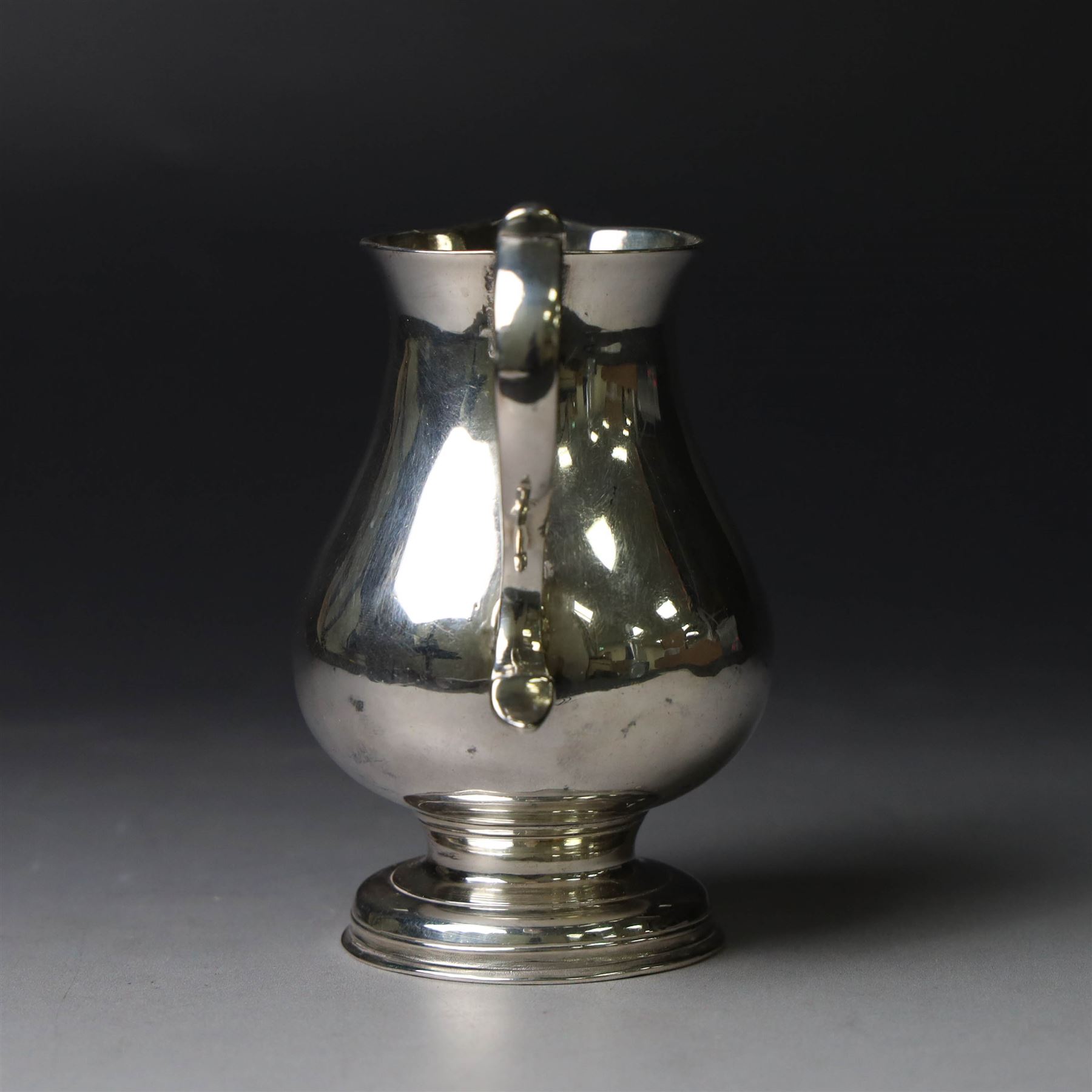 George II silver cream jug, of plain bellied form with capped scroll handle and sparrow beak, upon stepped circular foot, hallmarked London 1737, makers mark indistinct, H8.5cm
