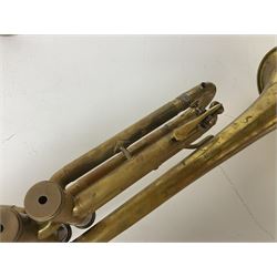 Three brass trombones comprising Elkhart Ind. USA 'CONN' model no.72H; Besson 'Concord'; and Selmer Distributed 'Lincoln'; two in carrying cases; and German B & M 'Champion' brass trumpet (4)