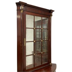 Pair of French Empire design corner cabinets, the straight-front upper section with canted corners and applied half-column pilasters, enclosed by mirror glazed door, the bow-front lower section enclosed by two doors with applied mouldings, mounted by cast metal floral rosettes, skirted base with cast gilt metal hairy paw brass feet