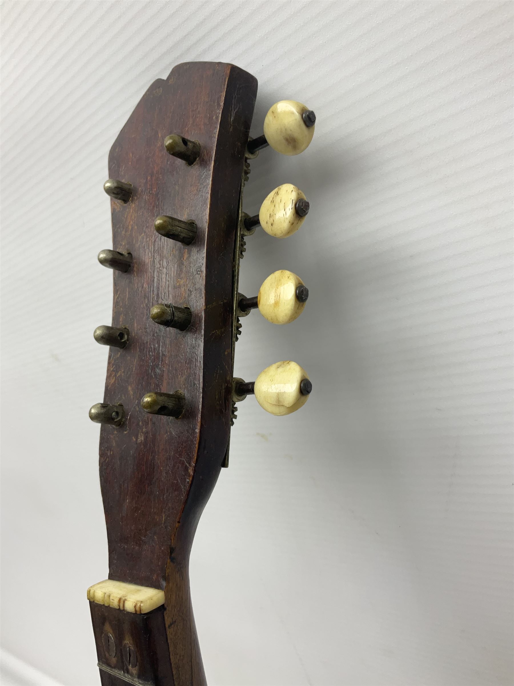Late 19th century Italian lute back mandolin with segmented bowl back, bears label Gennaro Maglioni Napoli L61cm; in ebonised wooden case; together with another similar damaged Italian lute back mandolin for restoration or spares (2)