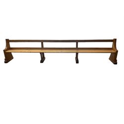 Early 20th century ecclesiastical pine bench or church pew, raised on chamfered supports with sledge feet
