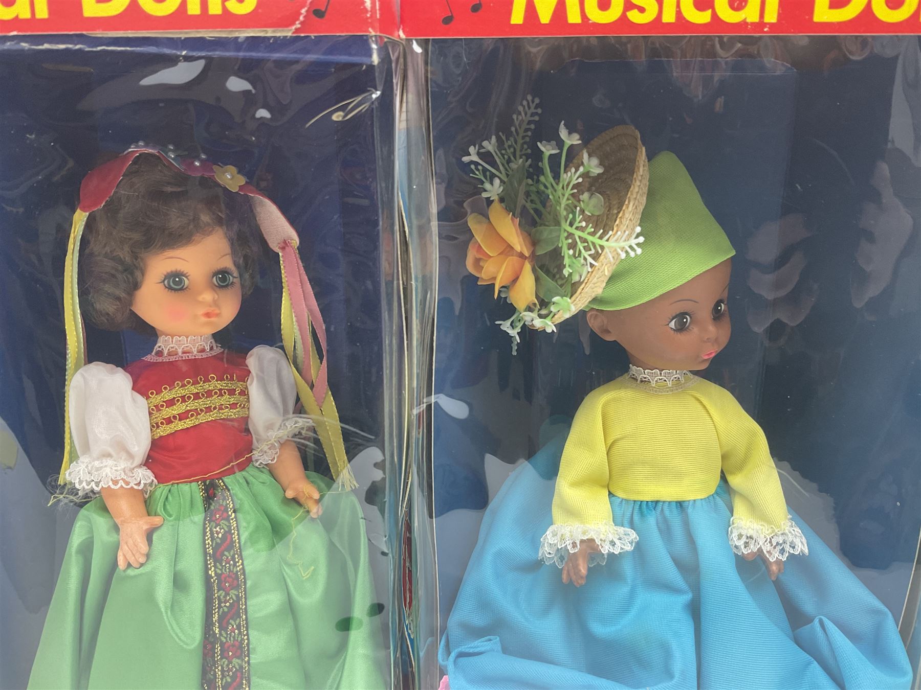 Four Mayfair Products Musical Dolls of Many Lands; original boxes and delivery boxes; and set of twelve Nationality Dolls with Sleeping Eyes; boxed (16)