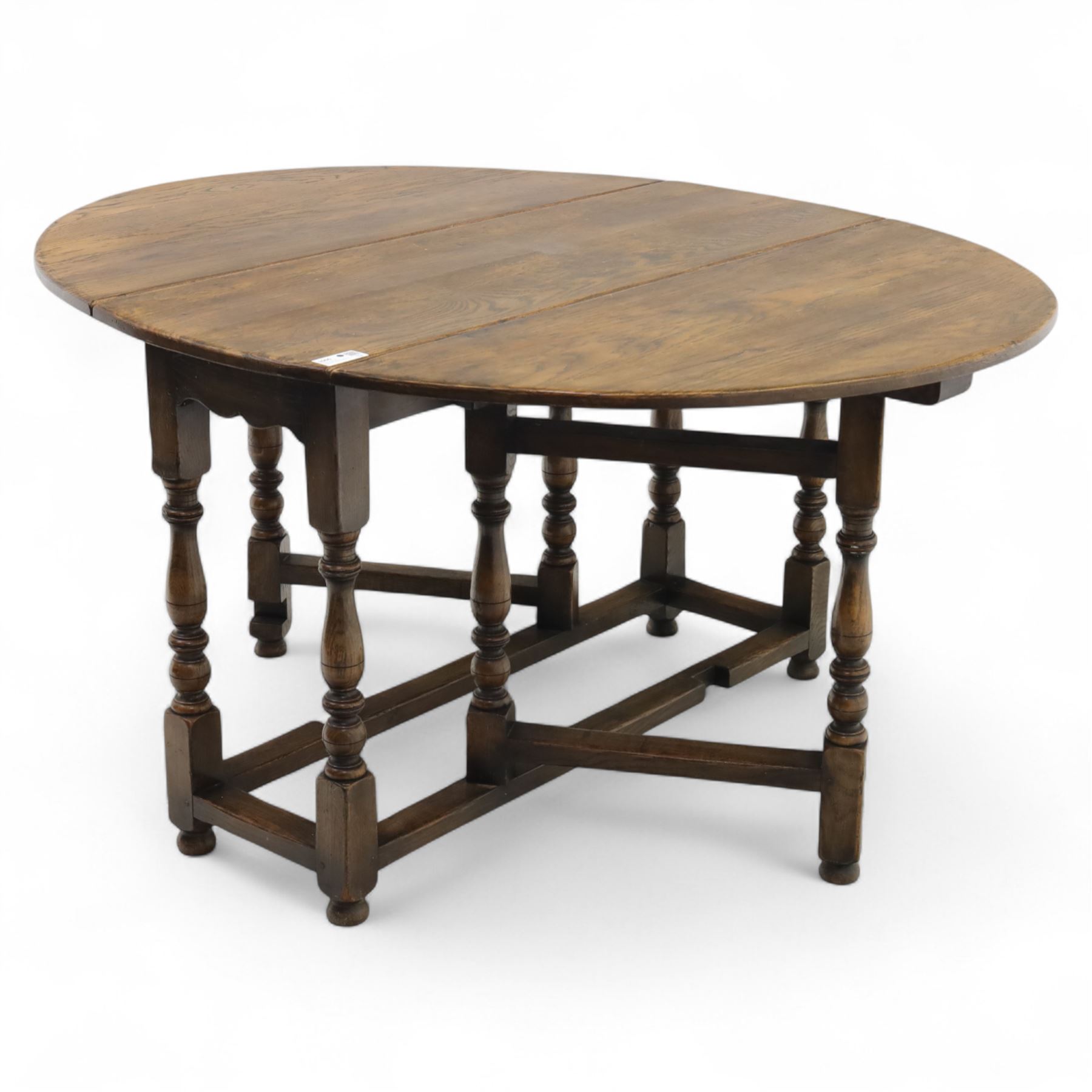 17th century design oak gateleg dining table, oval drop-leaf top on baluster turned supports, twin swinging gate legs united by peripheral stretchers (Extends to 149cm)