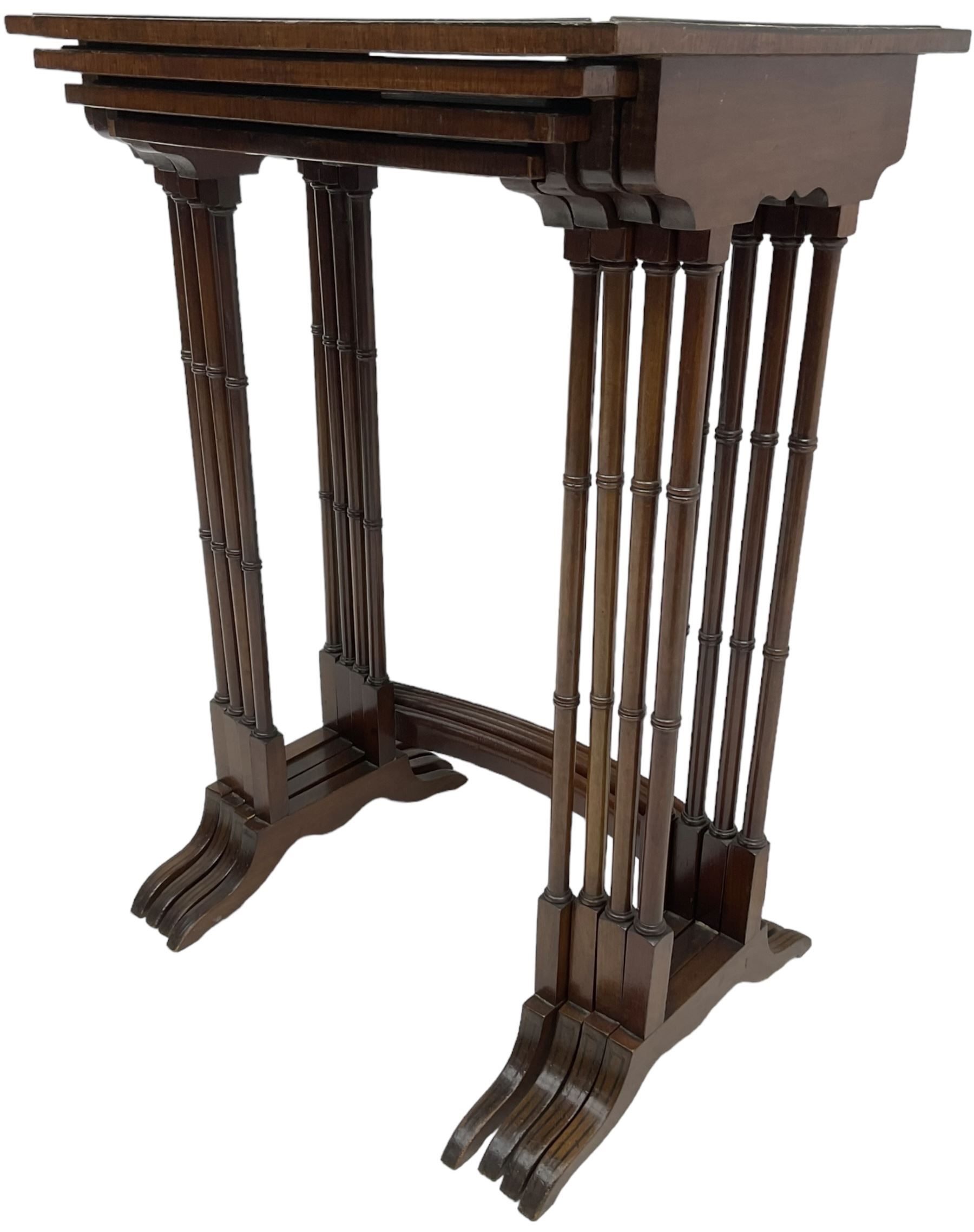 20th century inlaid mahogany quartetto nest of four tables, rectangular top inlaid with birdseye maple oval panel, ring turned supports on sledge feet