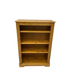 Pine open bookcase, fitted with four adjustable shelves, fluted uprights, on bracket feet 