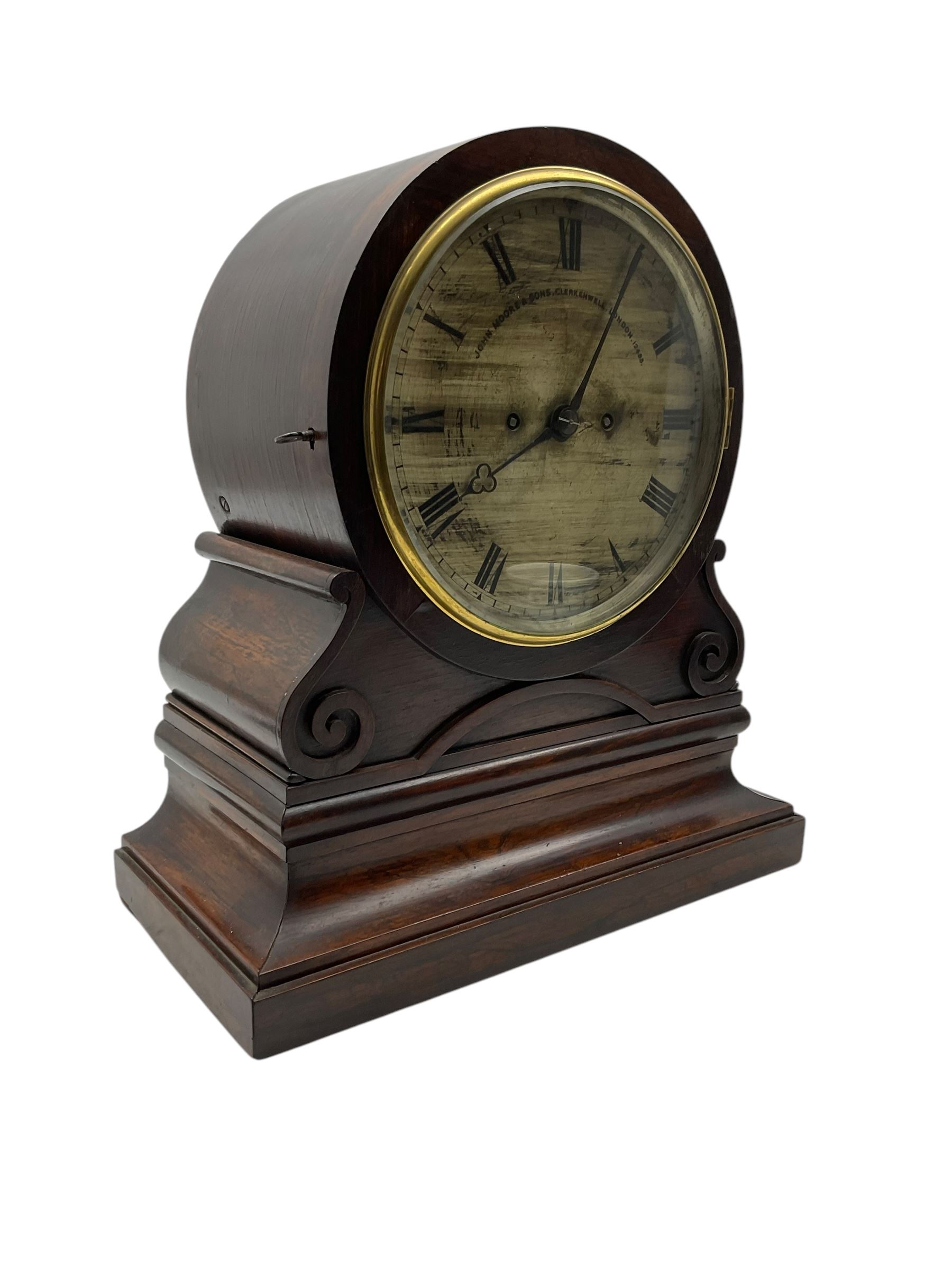 John Moore & Sons of Clerkenwell, London- late 19th century 8-day twin fusee mantle clock in a rosewood circular drum case raised on an ogee scroll support and broad plinth, rear door with silk backed fretwork (detached),  8