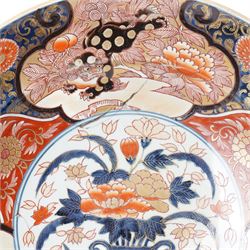 Japanese 18th century Edo period Imari porcelain charger, painted with a central peony in vase within a border of kiku and spotted shi-shi, D54cm 